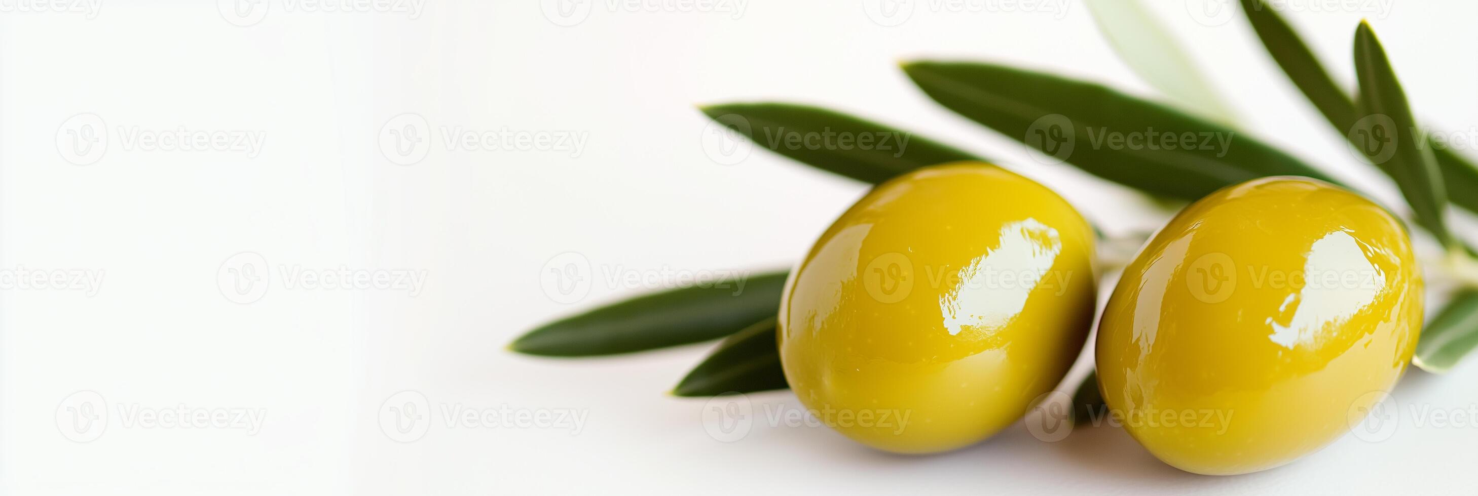 Two olive oil capsules with leaves on a white background photo