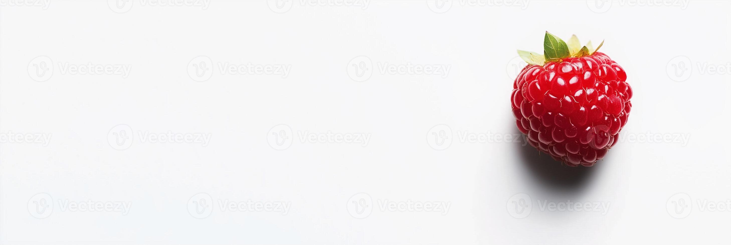 A raspberry is shown on a white surface photo