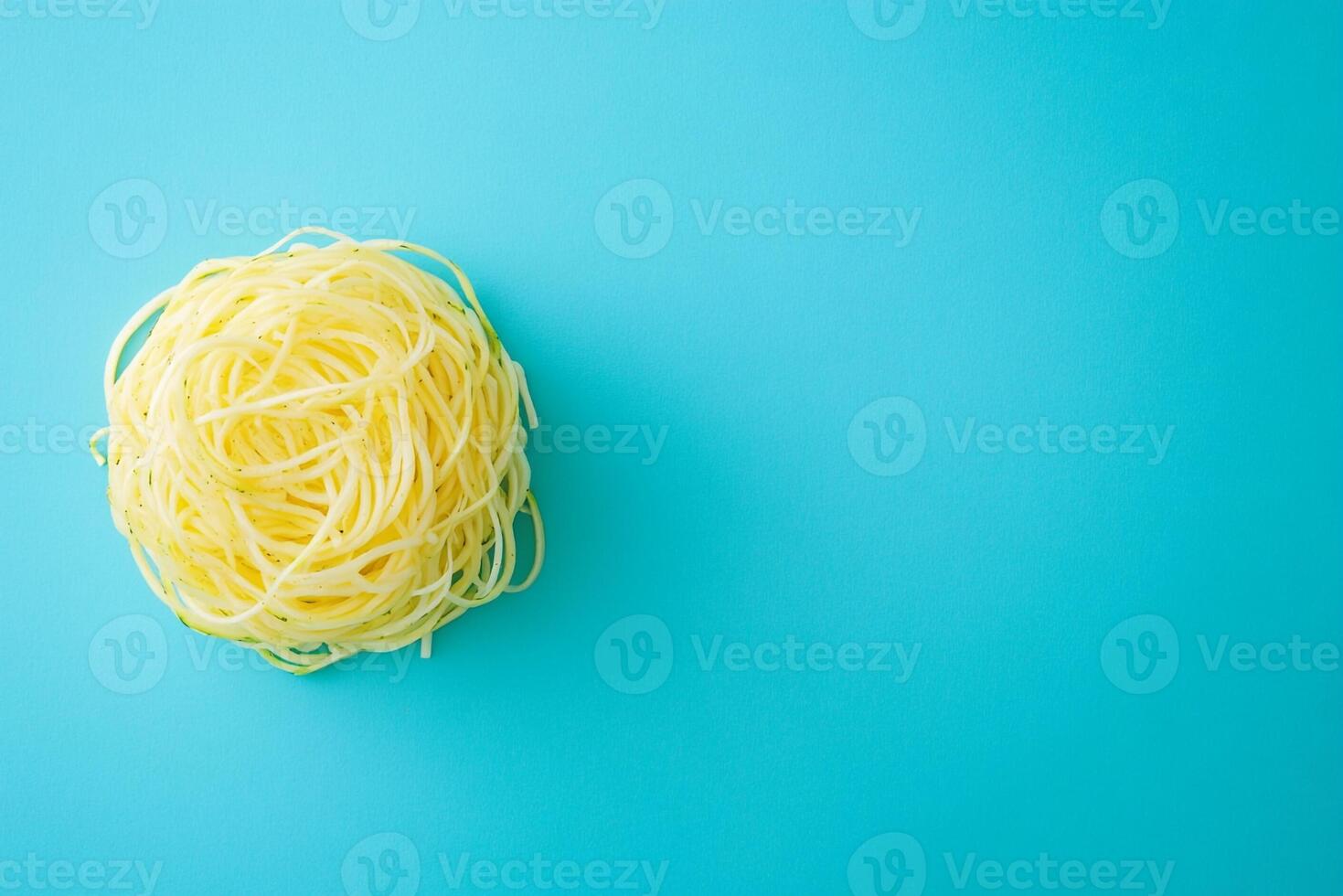 Top View Of Raw Zucchini Noodles With Almond Pesto On Vibrant Background With Copy Space, Food Photography photo