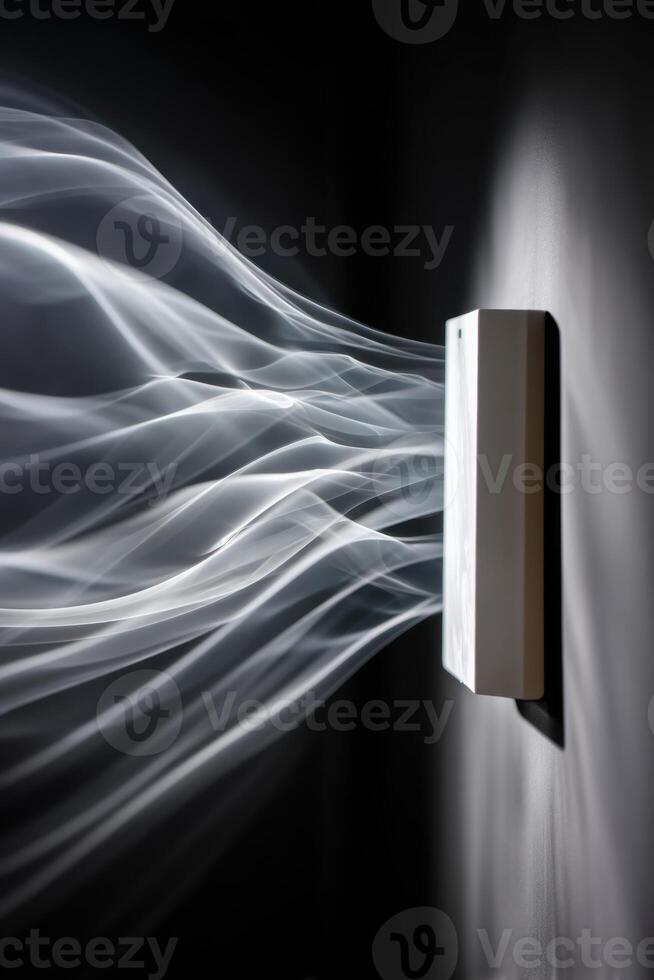 White smoke spreading from a wall diffuser in a dark room photo