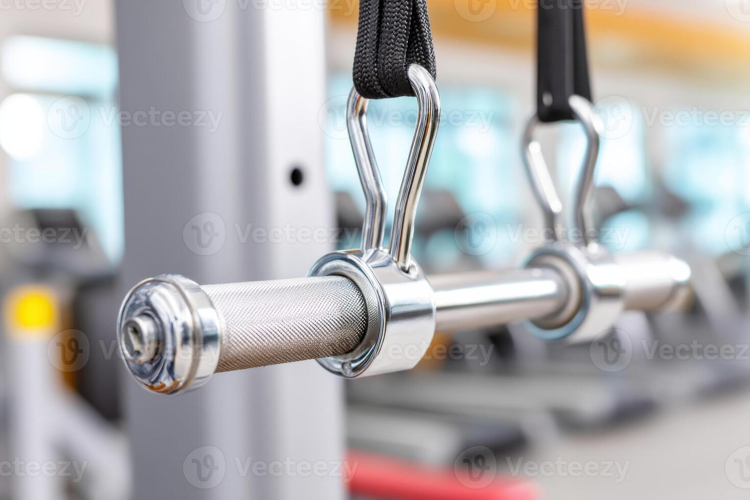 Close-up of lat pulldown bar hanging in modern gym photo