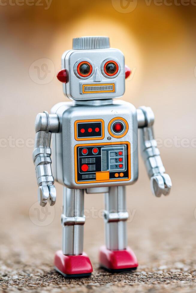 Retro robot toy standing on a concrete surface photo