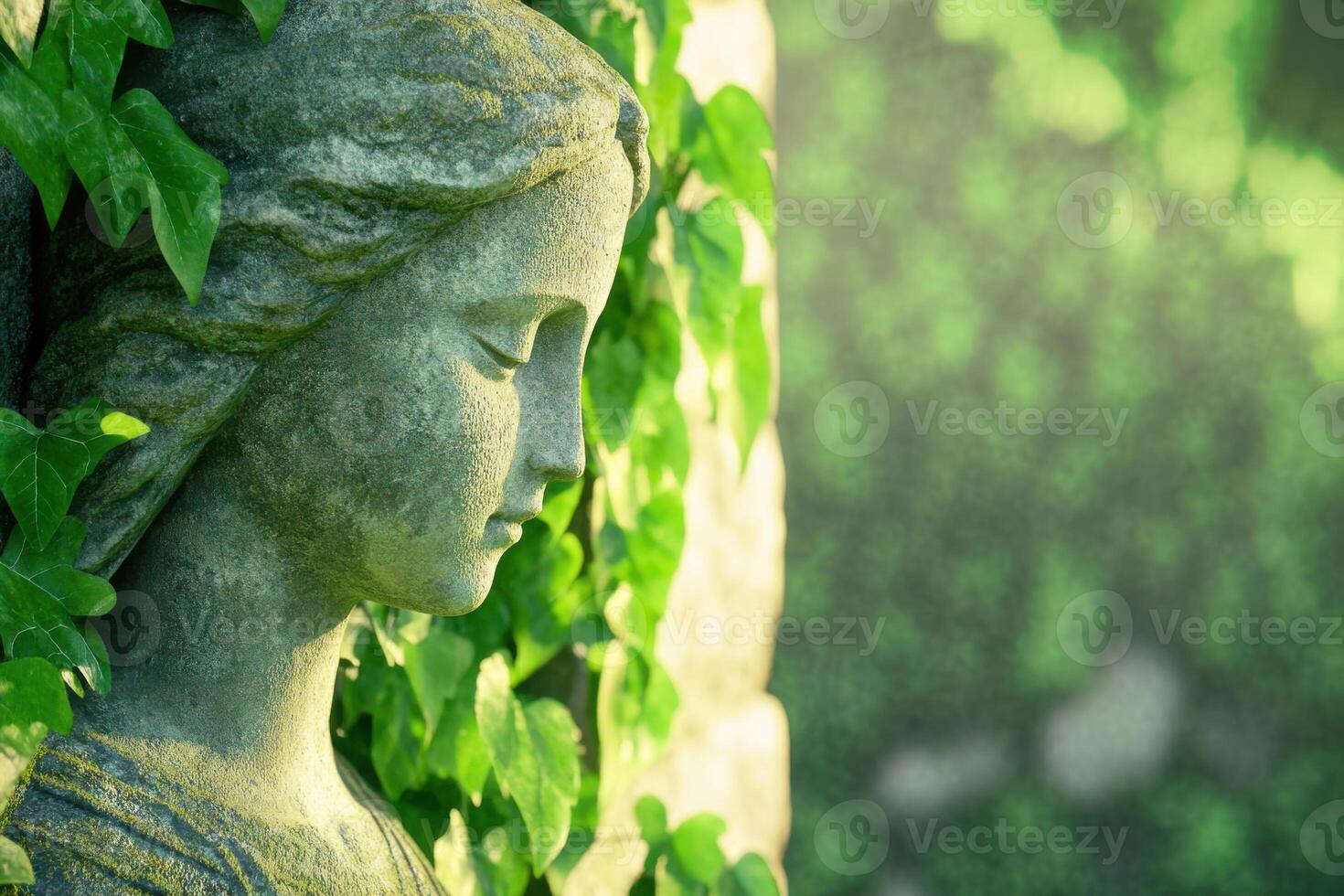 Serene angel statue surrounded by ivy in a peaceful garden photo