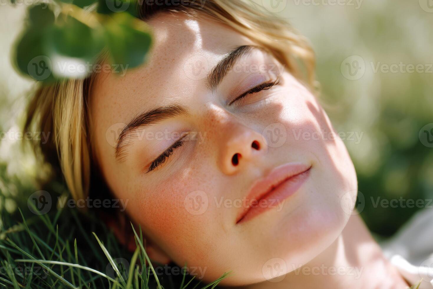 Relaxed woman enjoying nature with eyes closed, peaceful expression, surrounded by greenery and sunlight, capturing tranquility and serenity, healthy living concept photo