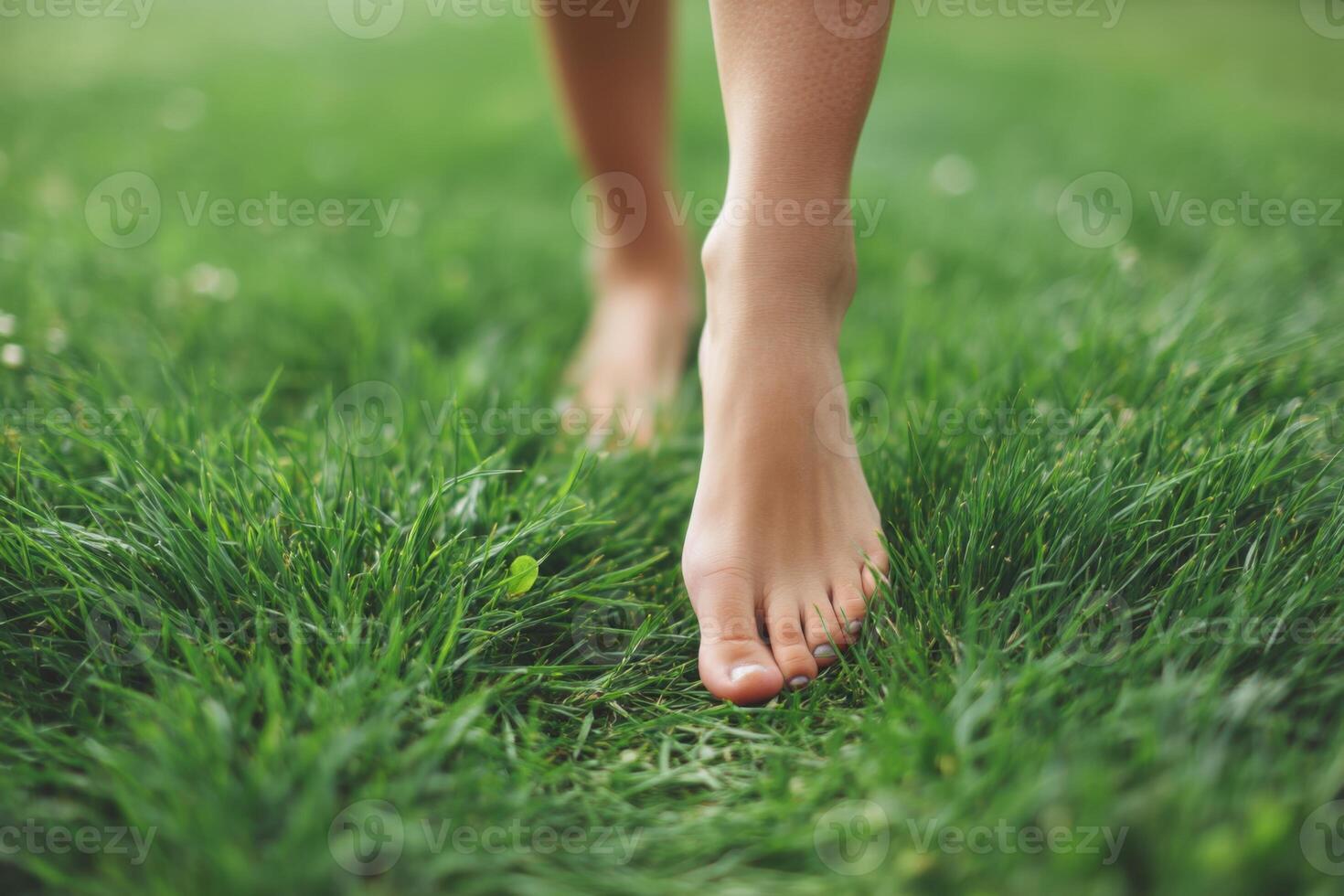 Walking barefoot on lush green grass in a serene outdoor setting promoting relaxation and connection with nature healthy lifestyle concept photo