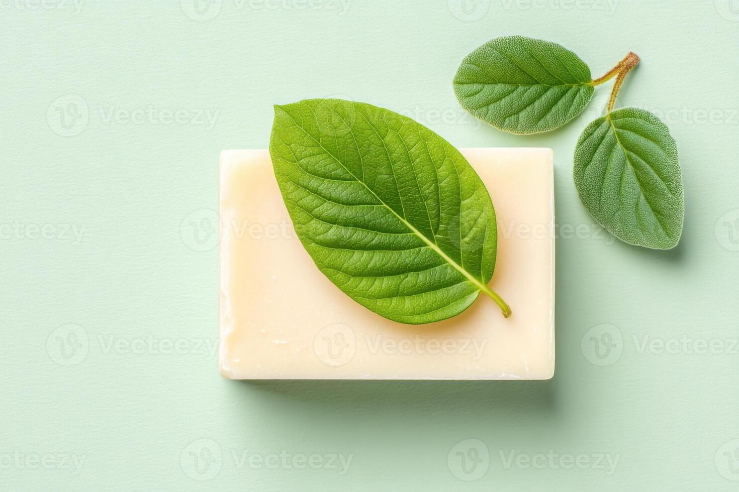 Natural soap bar with green leaves on a soft pastel background showcasing eco-friendly skincare and wellness practices promoting a sustainable lifestyle concept photo