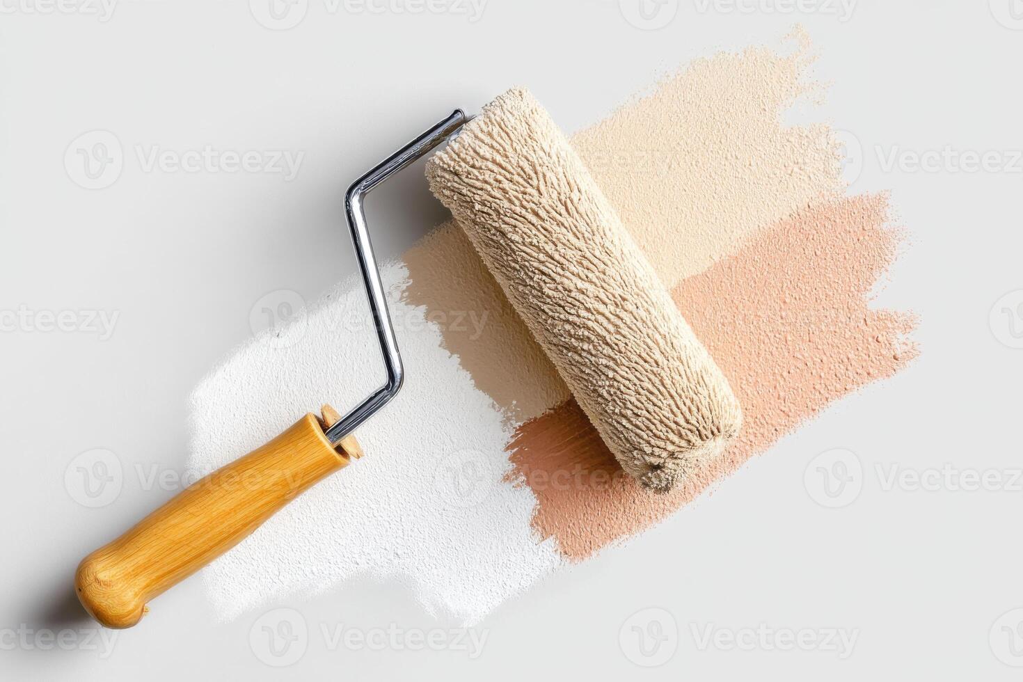 Paint roller resting on freshly applied strokes of creamy white, soft beige, and warm peach hues showcasing home renovation and artistic expression in interior design photo