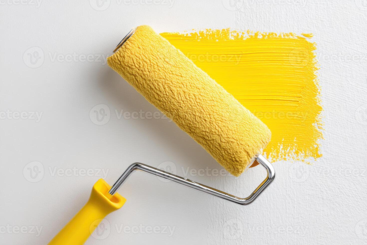 Bright yellow paint roller resting on fresh coat of vibrant yellow paint on white wall showcasing home improvement and creative DIY projects for interior design inspiration photo