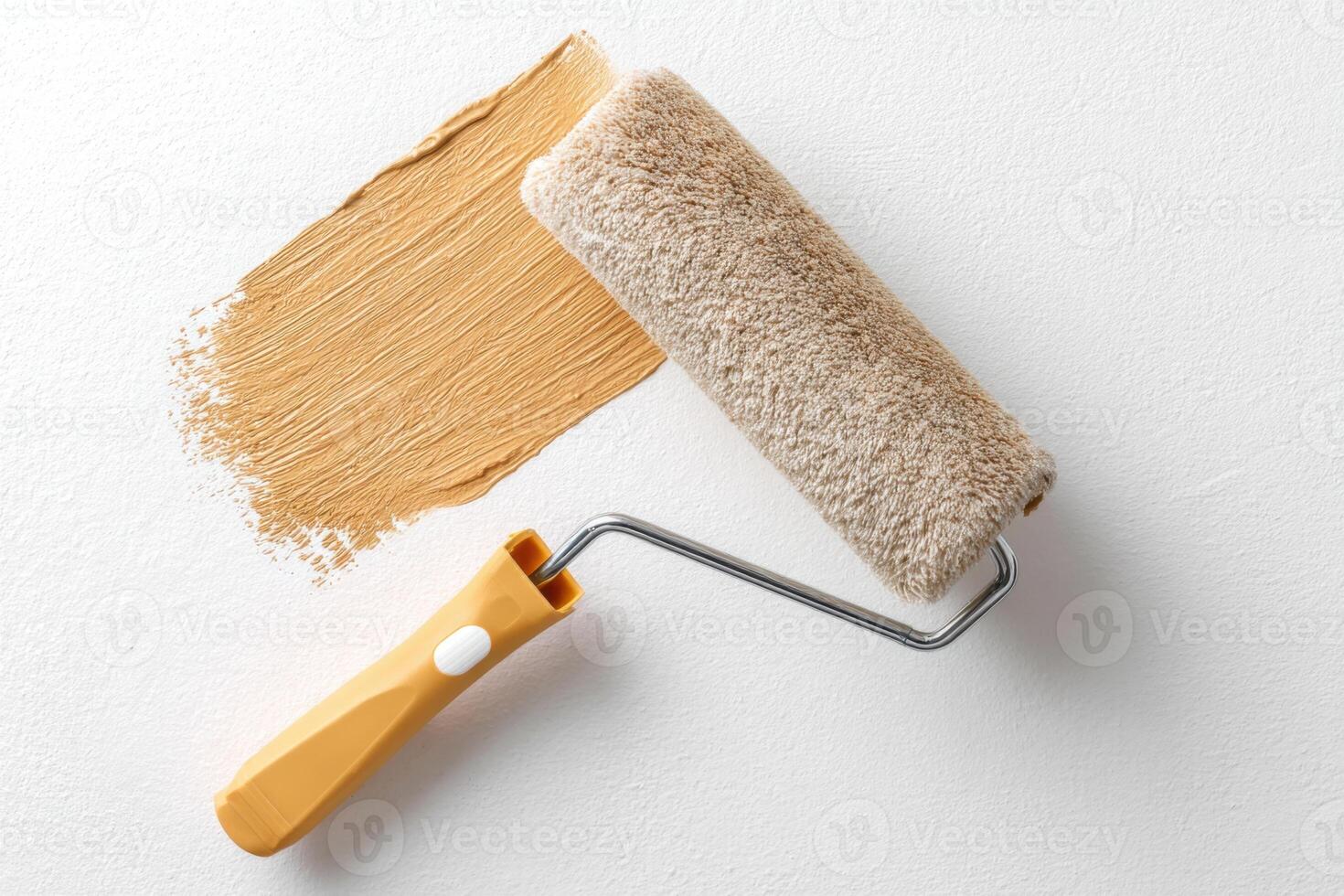 Paint roller with soft texture resting beside freshly applied warm beige paint stroke on smooth wall surface showcasing home improvement and renovation project photo
