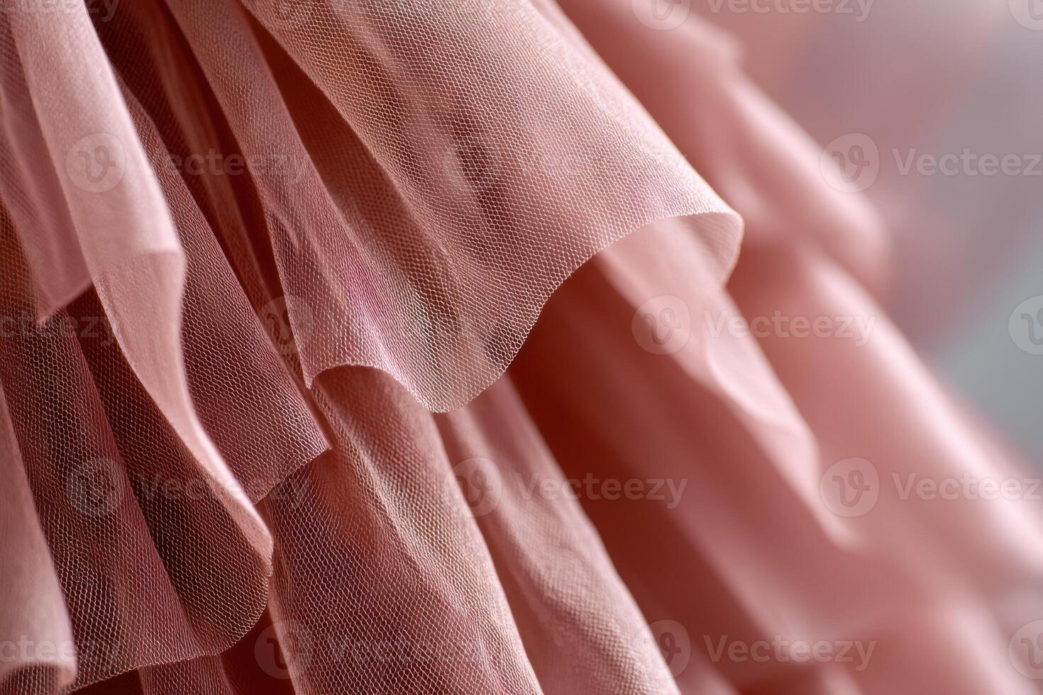 Delicate layers of soft pink tulle fabric create a beautiful texture, showcasing the elegance and intricacy of textile design in a fashion context with copy space photo