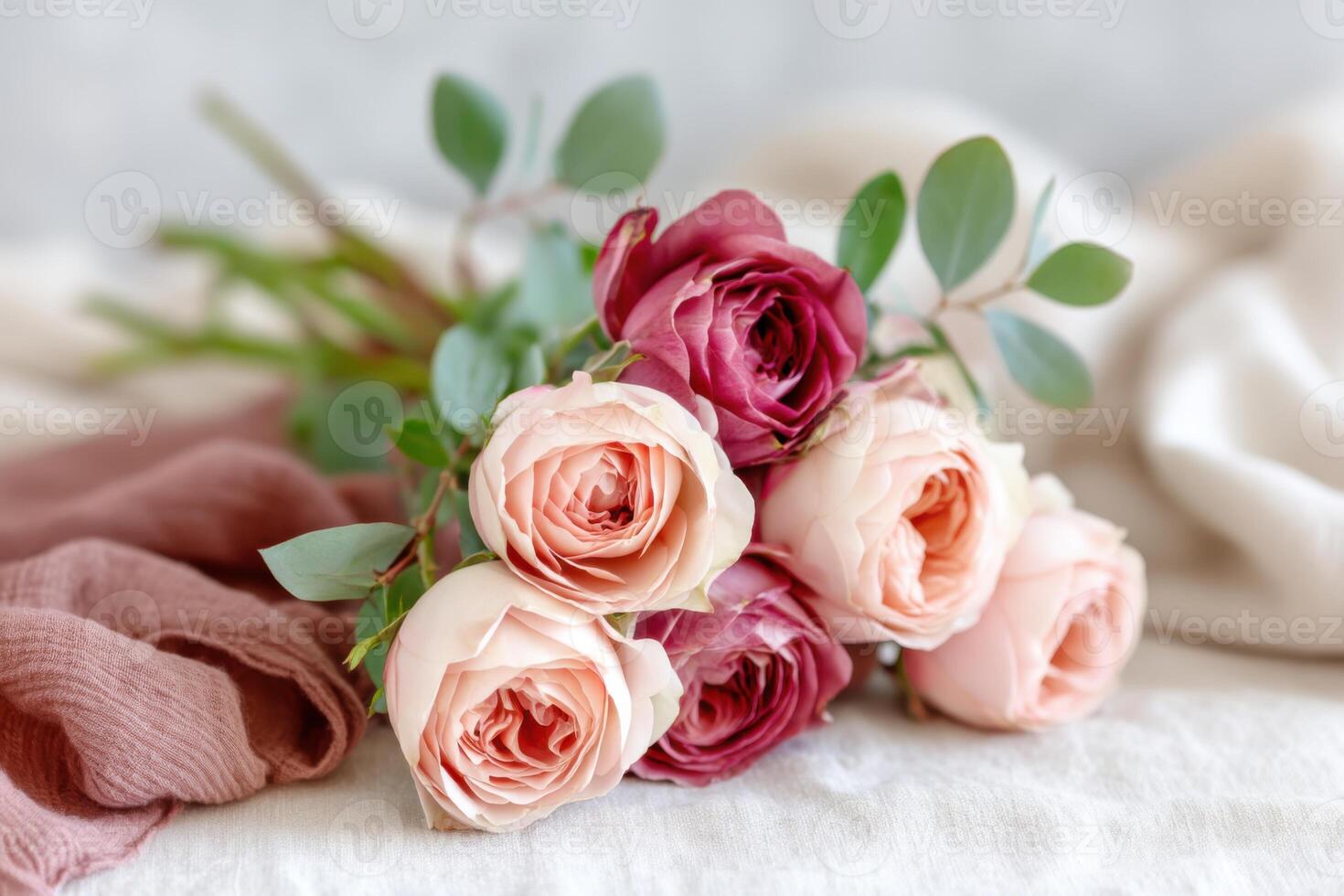 Bouquet of delicate roses in soft pastel colors arranged on a textured surface, showcasing natural beauty and elegance in floral design and composition photo