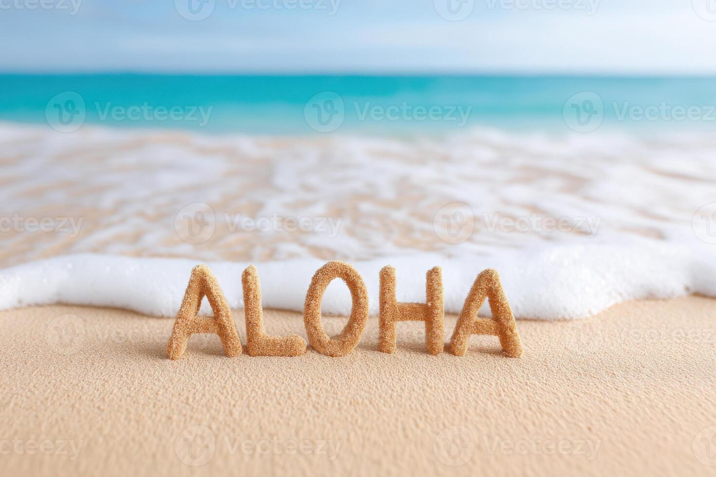 Sand letters spelling Aloha on a beach with gentle waves lapping at the shore, creating a serene atmosphere of relaxation and tropical vibes in a coastal setting photo