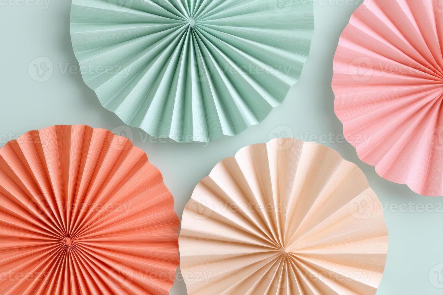 Colorful paper fans in pastel shades of green, pink, coral, and beige arranged on a soft background, creating a vibrant and festive atmosphere for decoration photo