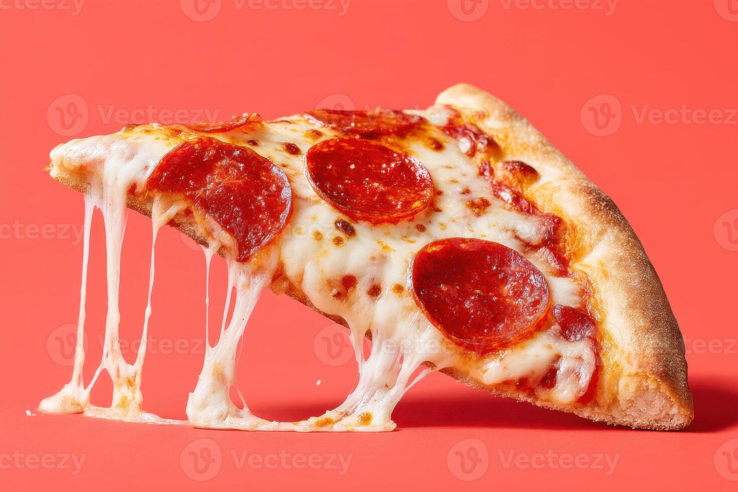 Delicious slice of pepperoni pizza with gooey melted cheese, set against a vibrant red background, showcasing appetizing textures and inviting presentation for food lovers photo