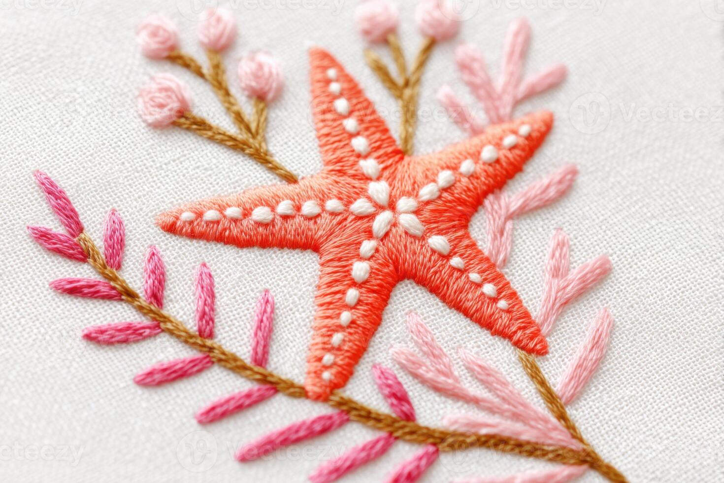 Embroidered starfish design featuring vibrant orange starfish and delicate pink floral elements on a soft fabric background, showcasing intricate stitching and artistic craftsmanship photo