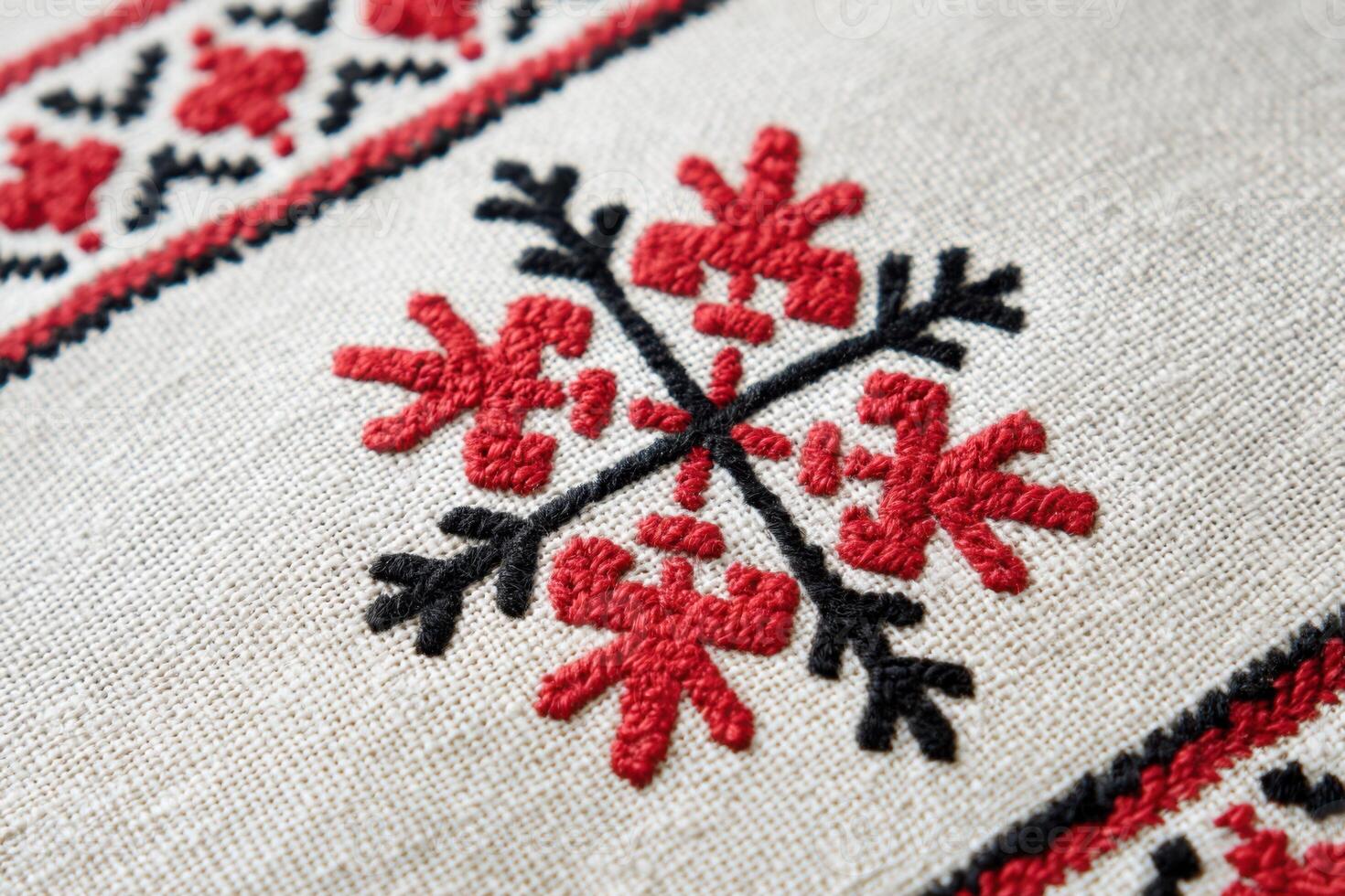 Ukrainian cross-stitch embroidery pattern featuring intricate red and black floral designs on a textured fabric background, showcasing traditional craftsmanship and cultural artistry photo