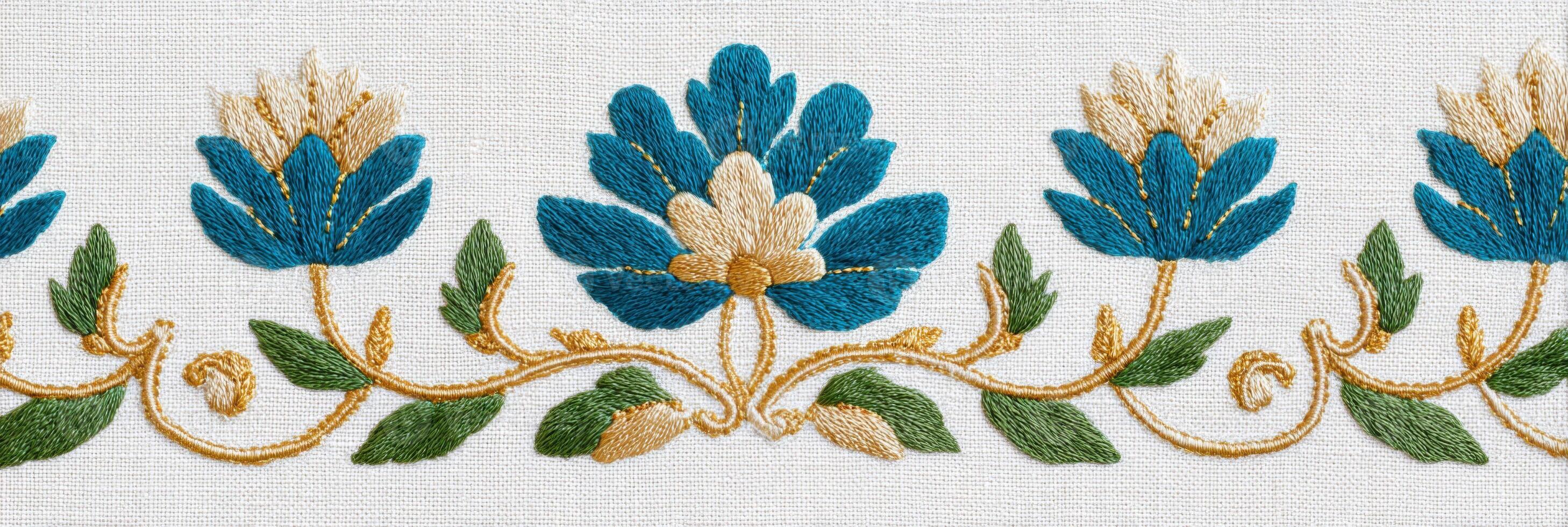 Vibrant floral embroidery design featuring blue flowers with intricate golden details on a soft white fabric background, showcasing craftsmanship and artistic expression in textile art photo
