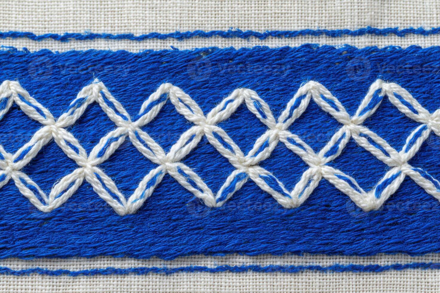 Moroccan textile featuring intricate blue and white embroidery with geometric patterns, showcasing traditional craftsmanship and cultural artistry in fabric design photo