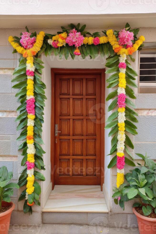 Traditional Indian door frame decorated with flowers and mango leaves garlands photo