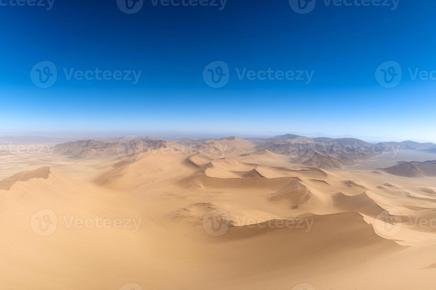 A desert landscape with mountains and sand dunes photo