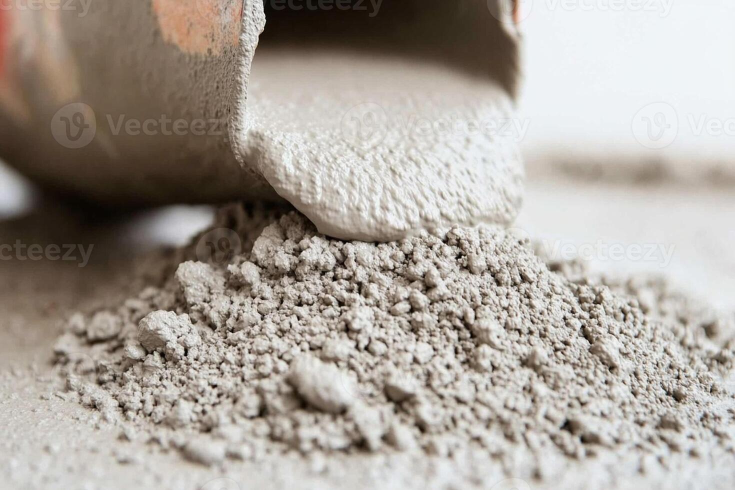 A cement mixer is pouring cement into a container photo