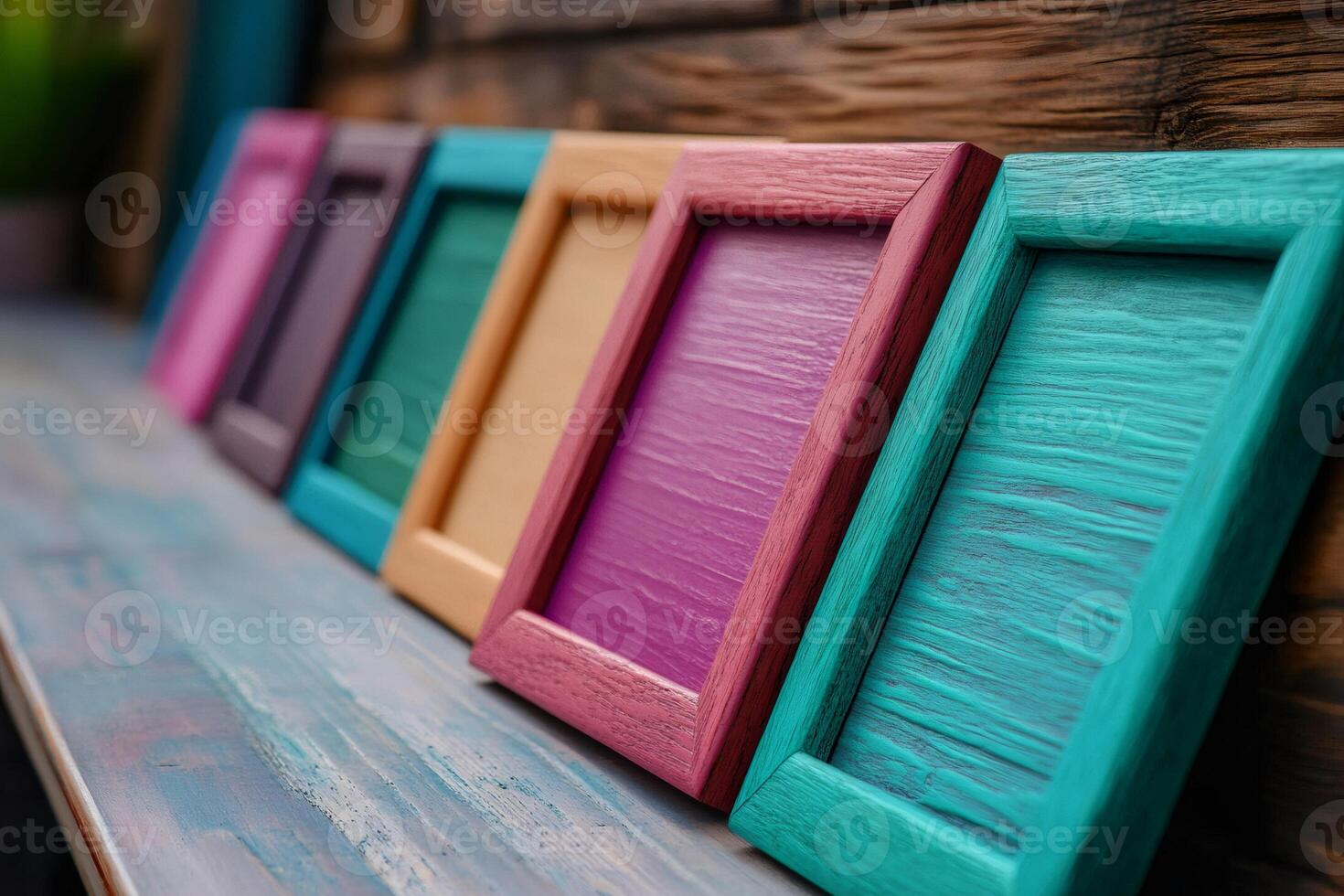 Colorful wooden picture frames leaning on rustic shelf photo