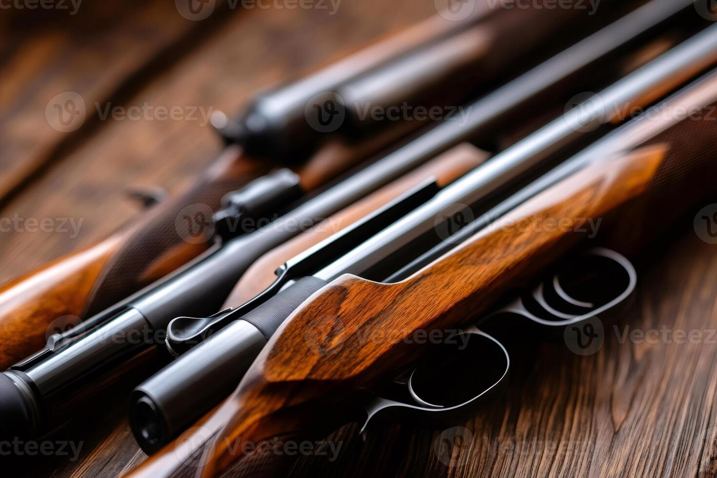 Hunting rifles with wooden stock resting on table. photo