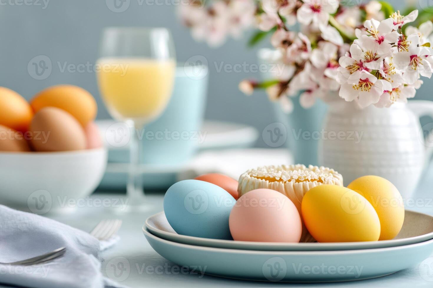 Easter eggs and cake decorating a festive table setting with spring flowers and orange juice photo