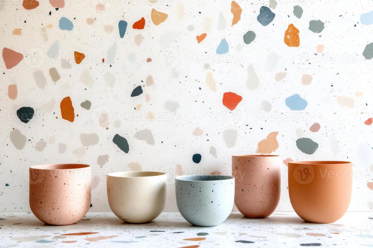 Five empty flower pots sitting on terrazzo countertop and background photo