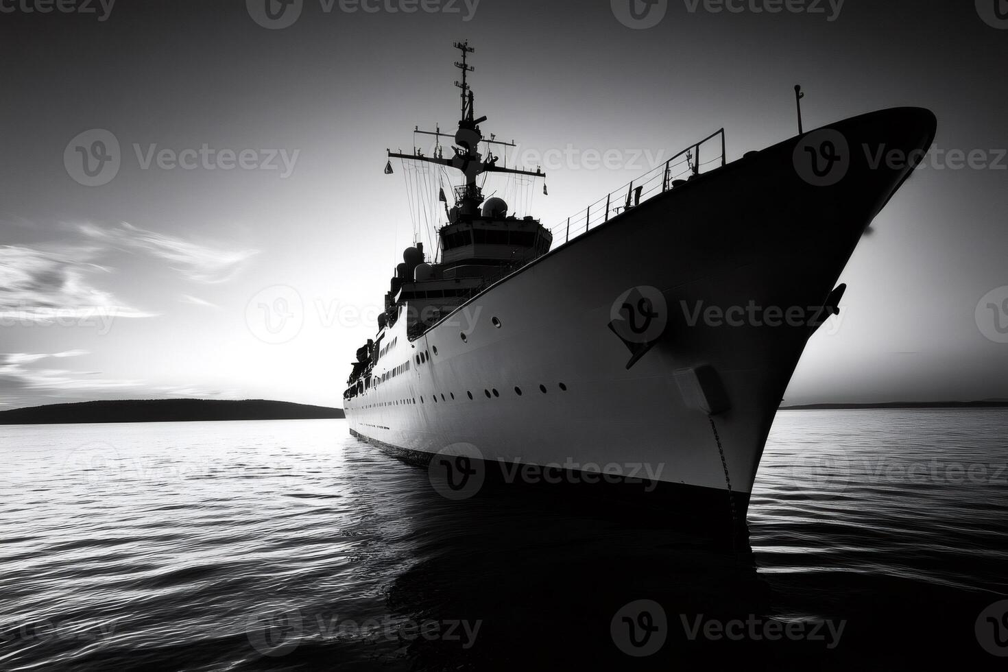 Large military warship sailing on calm ocean at sunset in black and white photo