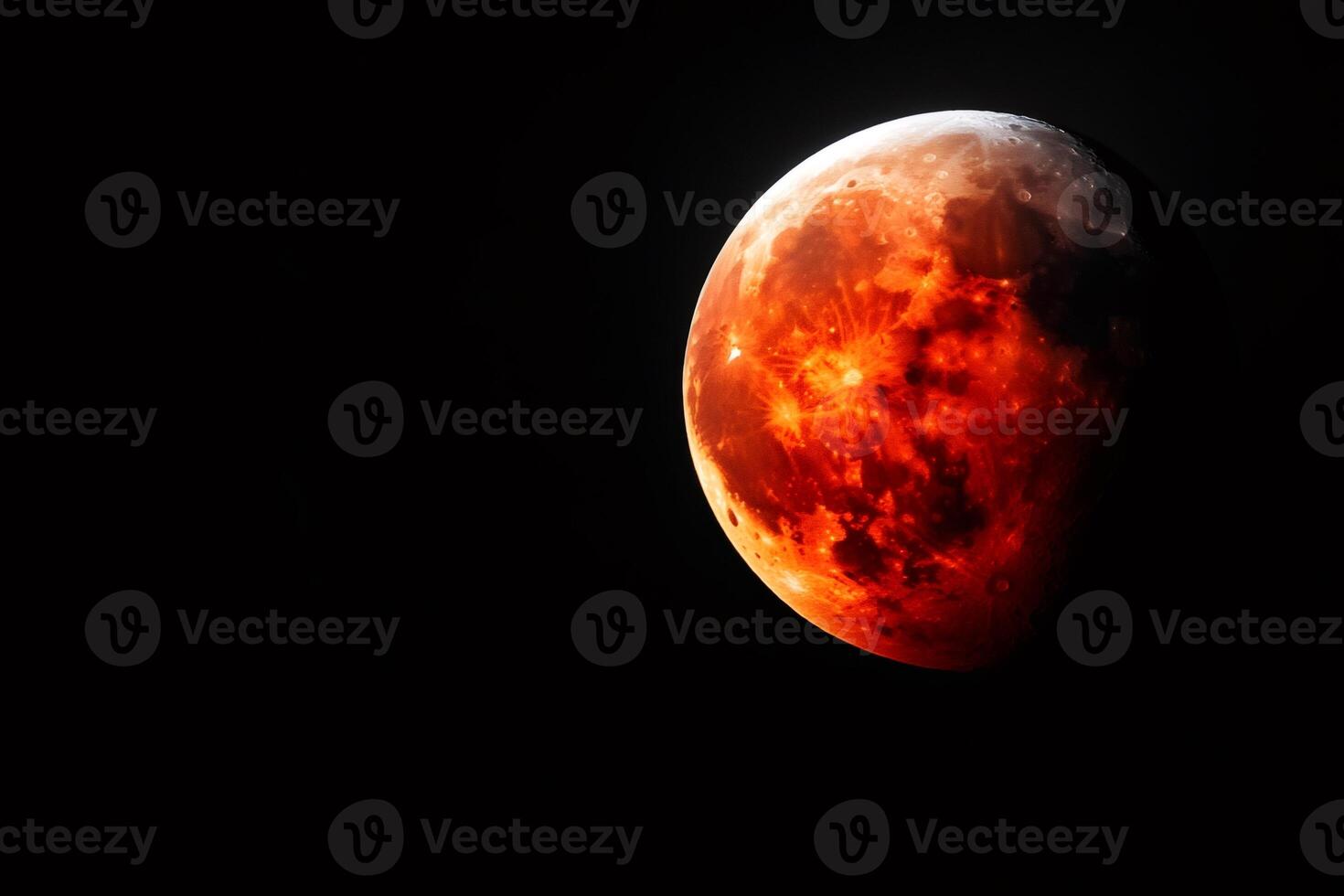 Red moon glowing in the night sky during a total lunar eclipse photo