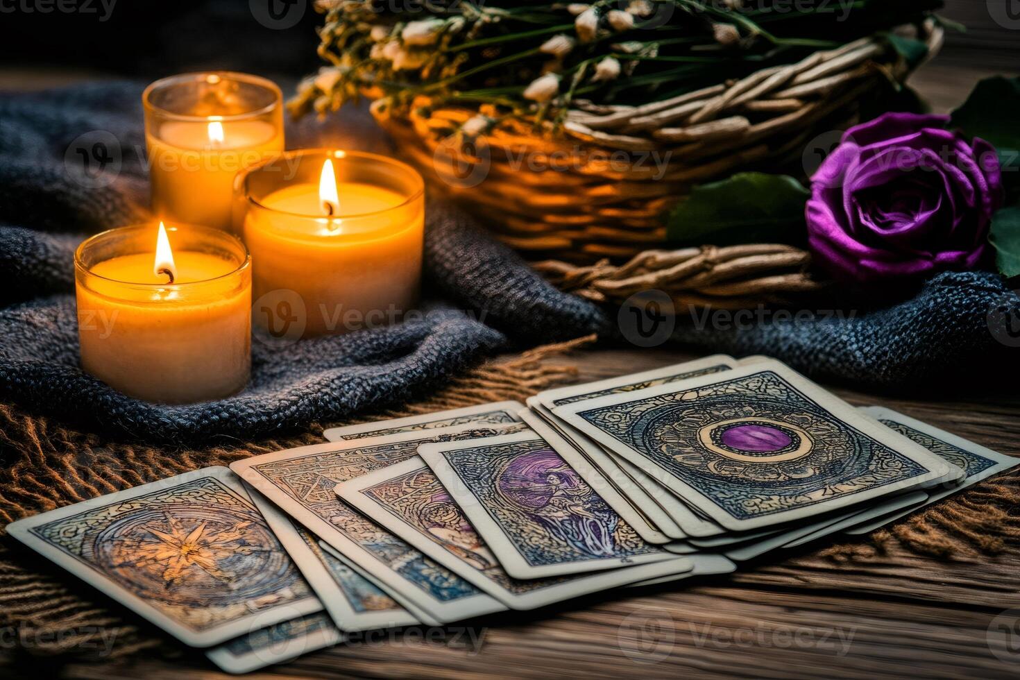 Fortune teller desk displaying tarot cards, burning candles and dried flowers photo