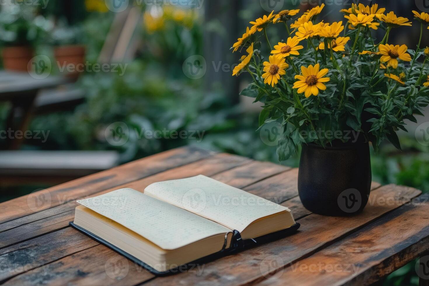 Open notebook and yellow flowers creating a peaceful reading environment photo
