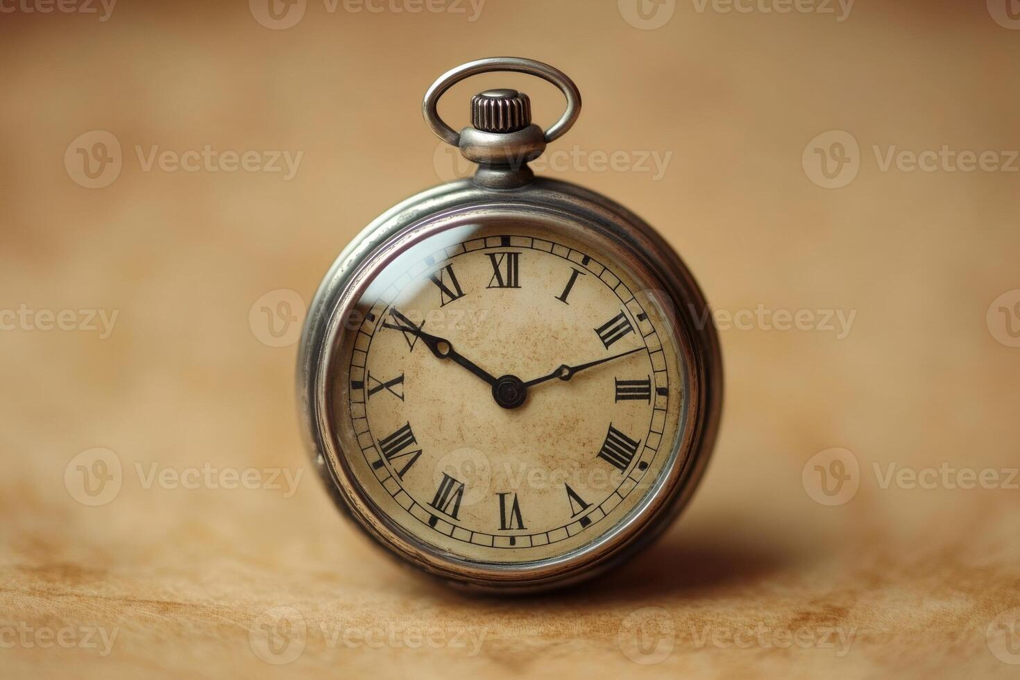 Vintage pocket watch showing time on wooden surface photo