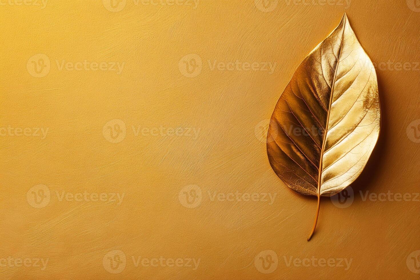 Golden leaf shining on golden background representing wealth and prosperity photo
