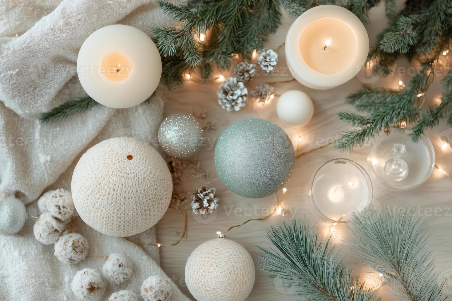 Christmas decoration with burning candles, pine branches and string lights creating cozy festive atmosphere photo