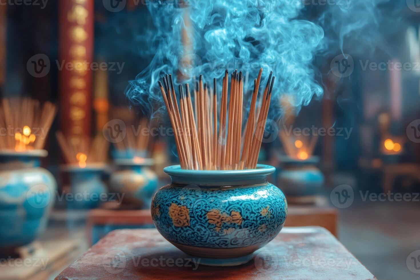 Incense burning in a decorated pot creating a mystical atmosphere in temple photo