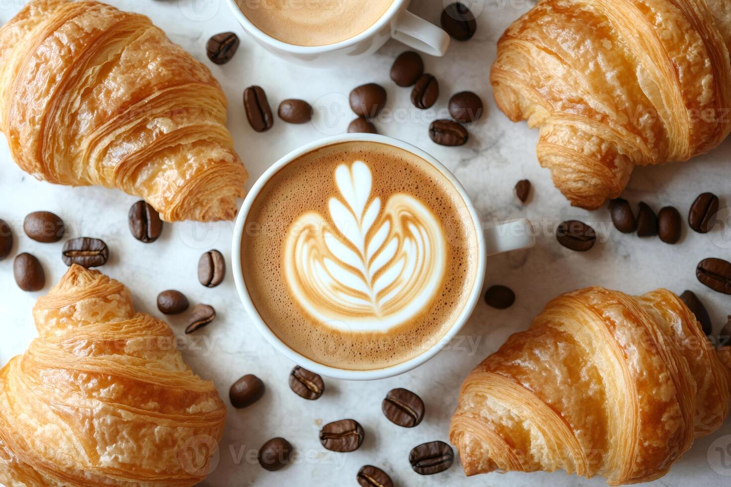 Freshly baked croissants and latte art coffee creating a cozy breakfast scene photo