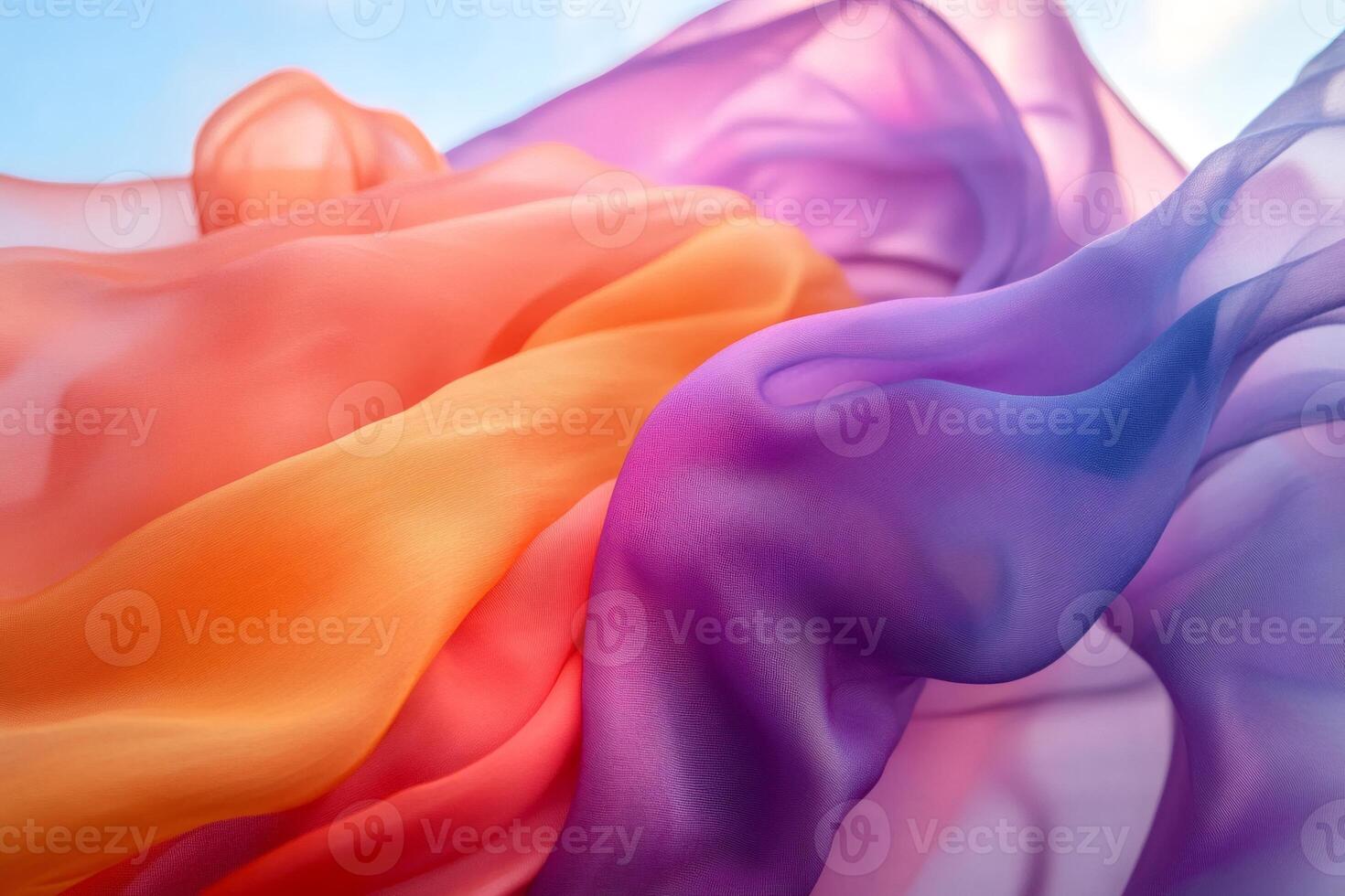 Colorful transparent fabric flowing in the wind creating abstract shapes photo