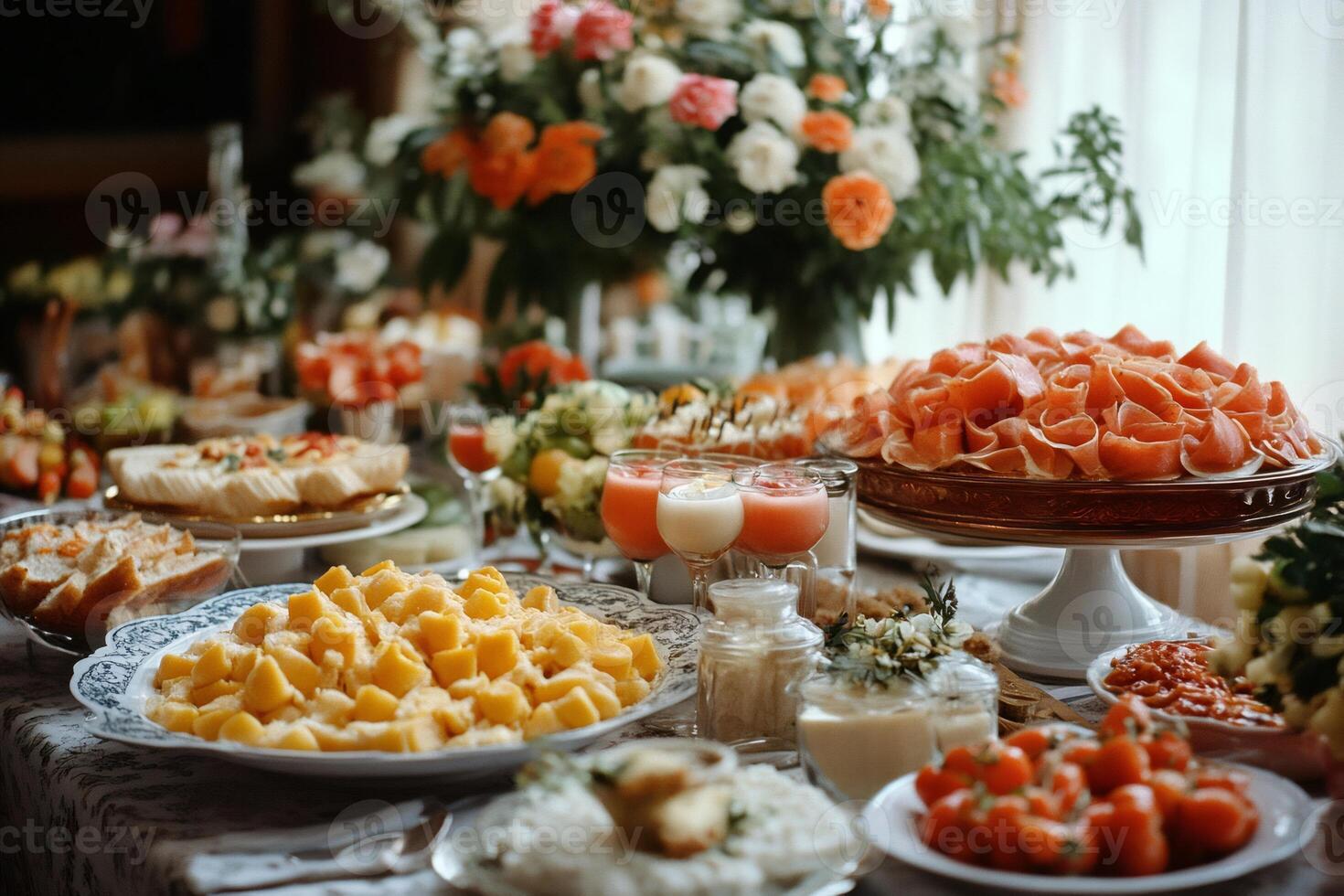 Catering buffet table decorated with flowers displaying delicious food and drinks photo