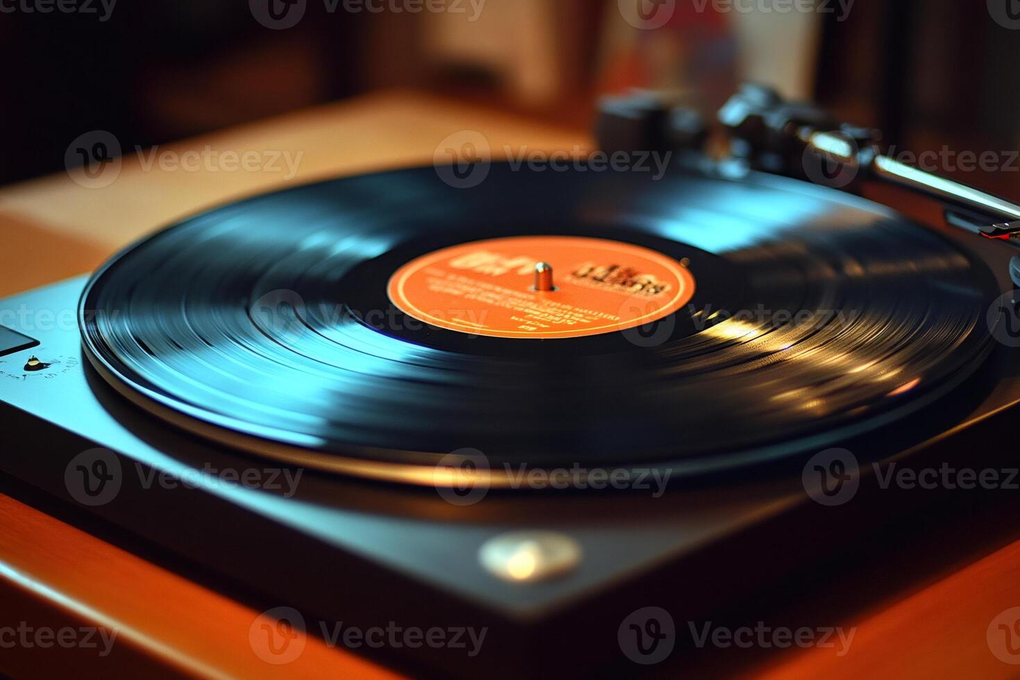 Vinyl record spinning on turntable playing music in warm light photo