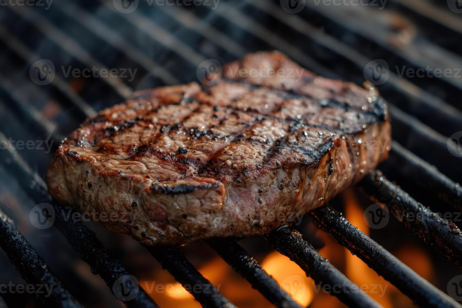 Grilled beef steak cooking on barbecue grill with flames photo
