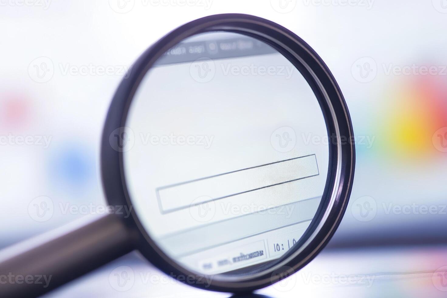 Magnifying glass revealing laptop screen reflecting windows, concept of computer security photo