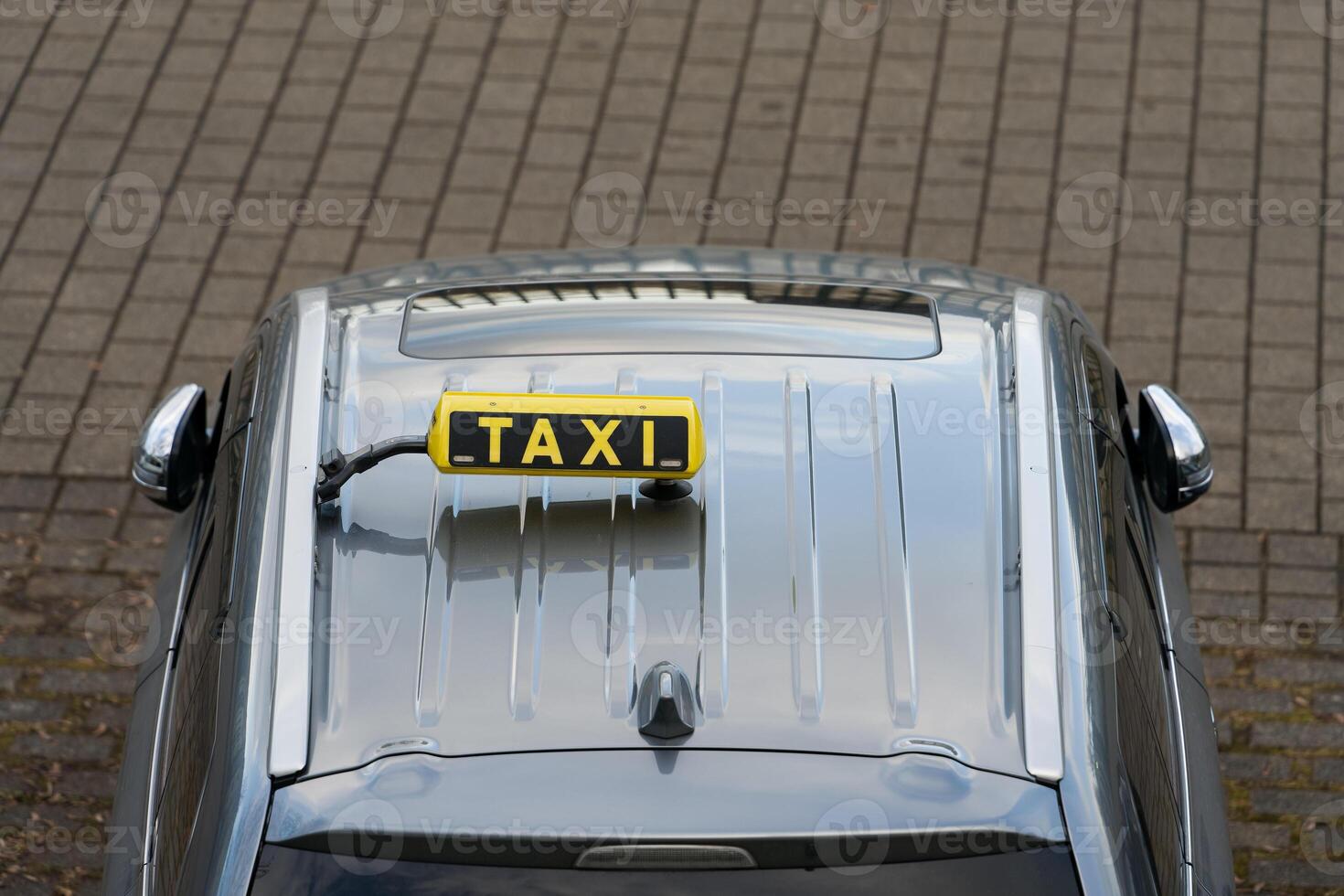 On the roof of the car there is a taxi sign. Photo of the roof of a taxi car from above. Taxi at the rank.