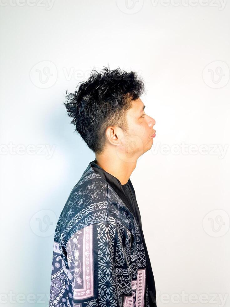 A man with curly hair wearing a black and pink jacket photo