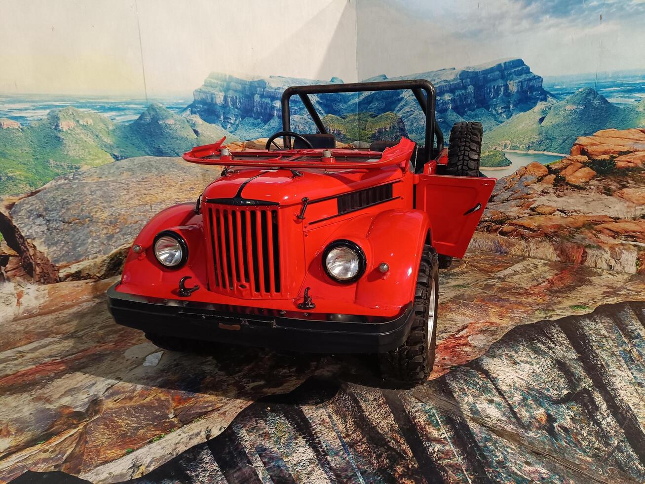 solo, central java - indonesia, april 22, 2025,Classic Red Mini Jeep Off Road Vehicle Mountain Landscape photo