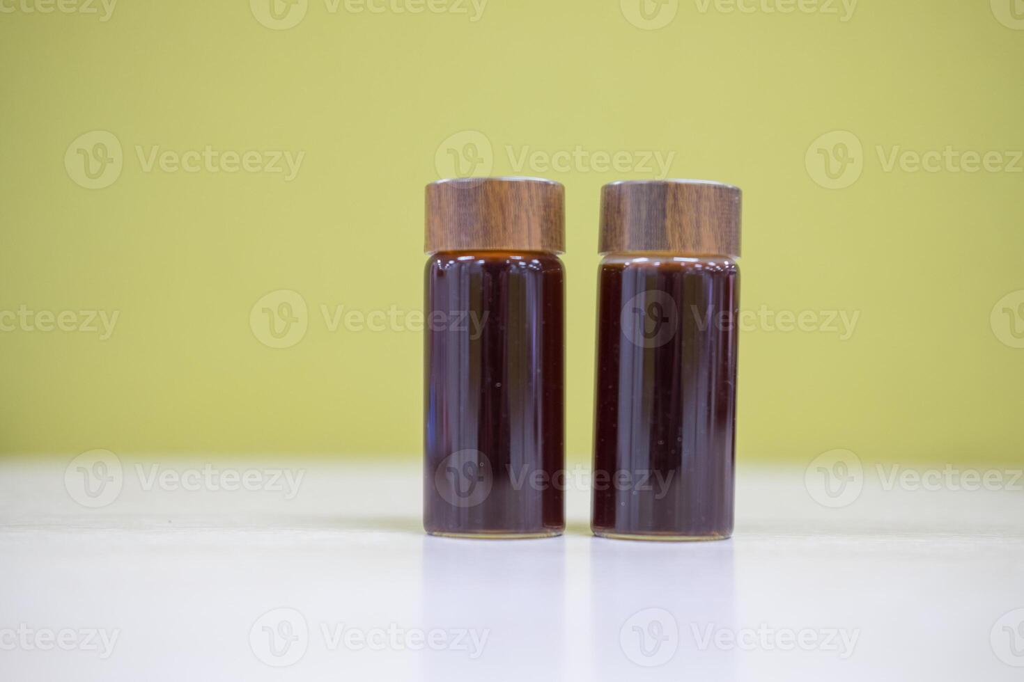 Shot of freshly coffee filling a small transparent glass jar. photo