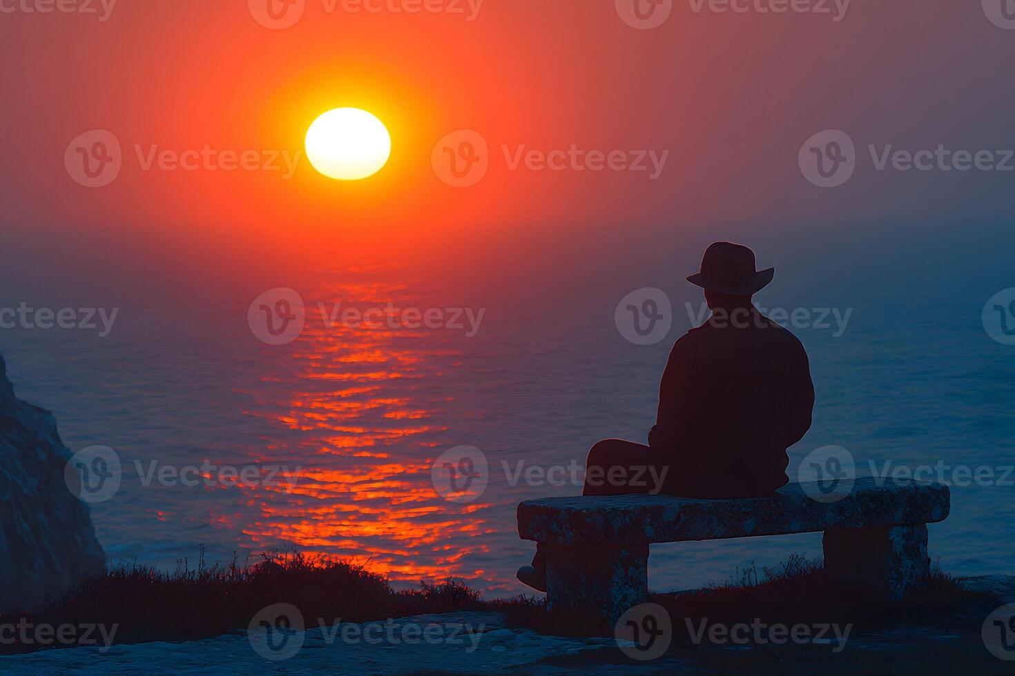 Solitude at Sunset Man Reflecting by the Ocean on a Stone Bench photo