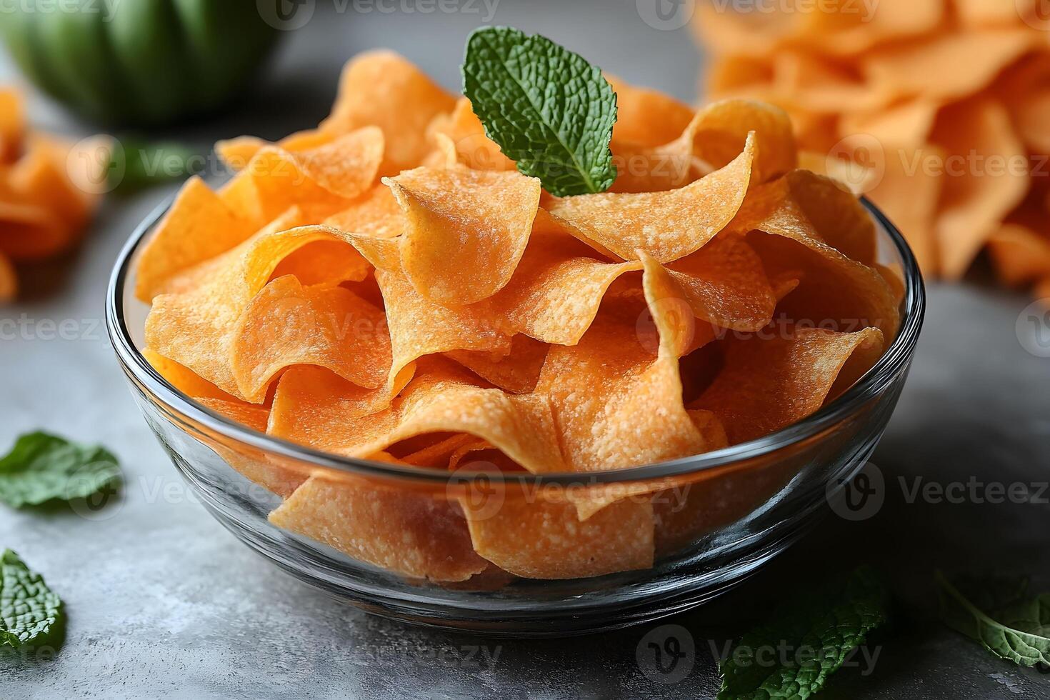Fresh Sweet Potato Chips in Glass Bowl with Mint Garnish - Perfect for Culinary Display and Snack Concepts photo