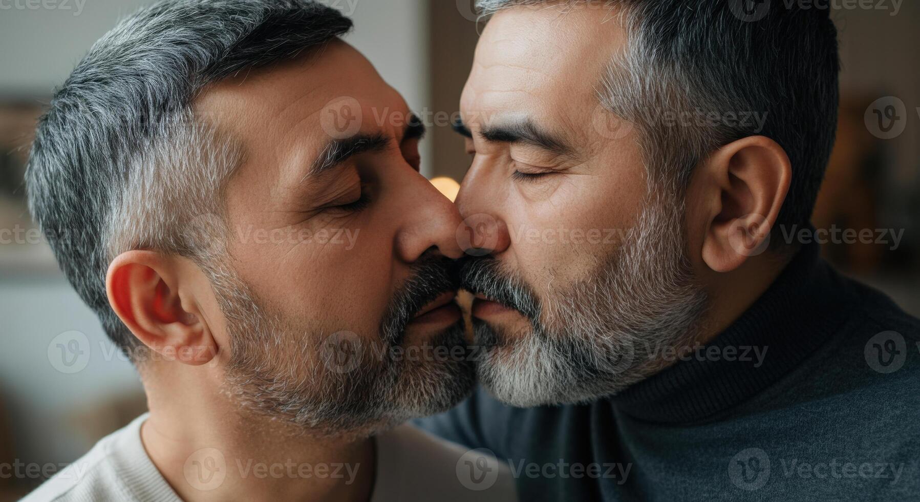 Mature same-sex couple embracing affectionately in intimate indoor setting photo